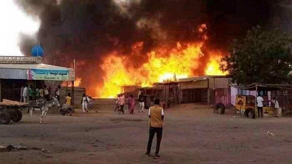 PHOTO: A man stands by as a fire rages in a livestock market area in al-Fasher, the capital of Sudan's North Darfur state, on September 1, 2023, in the aftermath of bombardment by the paramilitary Rapid Support Forces (RSF). (AFP via Getty Images)