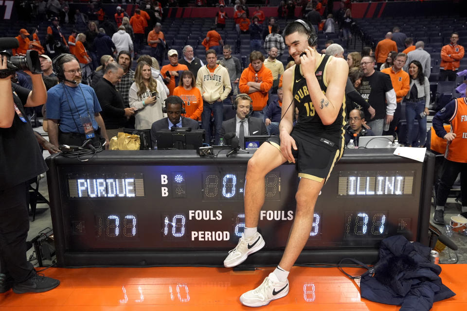 Purdue's Zach Edey smiles as he gives a television interview after the team's 77-71 win over Illinois in an NCAA college basketball game Tuesday, March 5, 2024, in Champaign, Ill. (AP Photo/Charles Rex Arbogast)