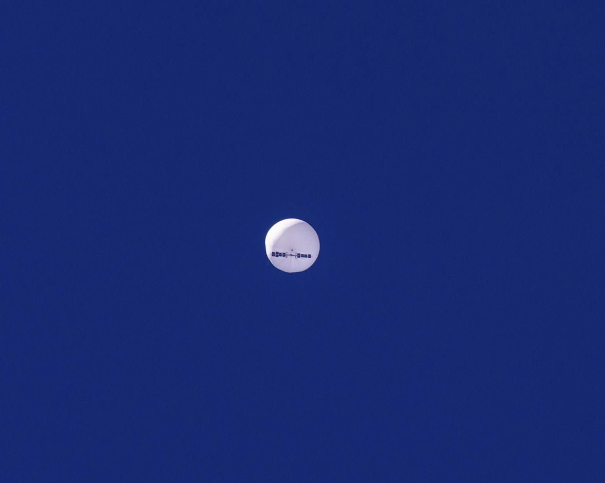 In this photo provided by Chad Fish, a large balloon drifts above the Atlantic Ocean, just off the coast of South Carolina, Saturday, Feb. 4, 2023. The balloon was struck by a missile from an F-22 fighter just off Myrtle Beach, fascinating sky-watchers across a populous area known as the Grand Strand for its miles of beaches that draw retirees and vacationers. (Chad Fish via AP)