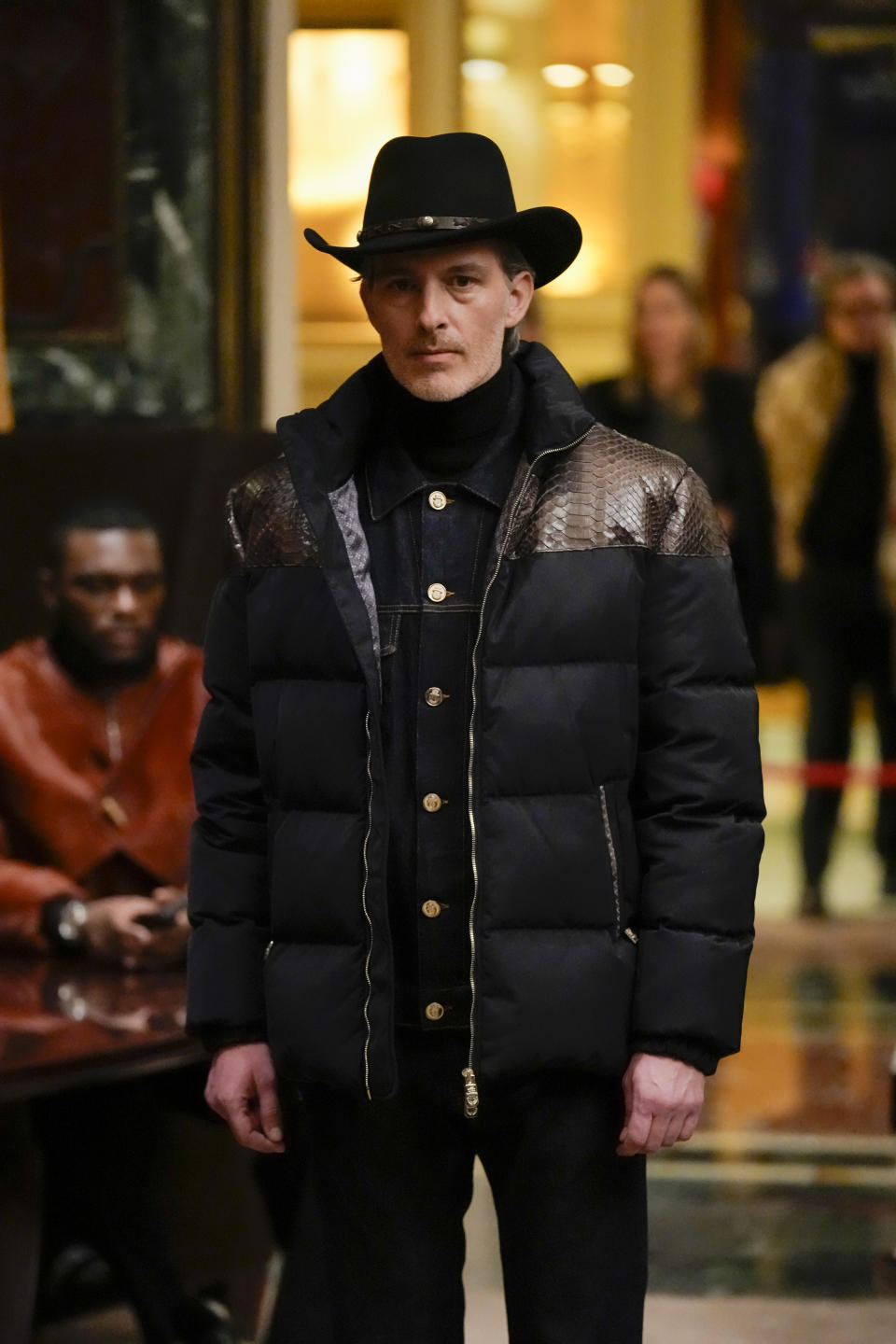 A model wears a creation as part of the men's Billionaire Fall-Winter 2024-2025 collection, that was presented in Milan, Italy, Friday, Jan. 12, 2024. (AP Photo/Antonio Calanni).