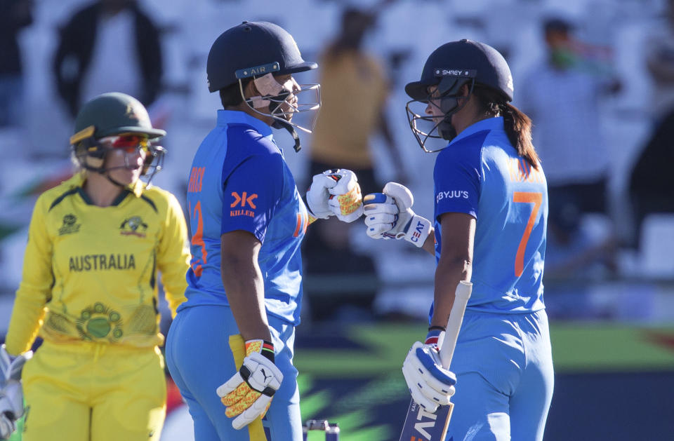 India's Richa Ghosh, left, congratulates India's Harmanpreet Kaur on scoring 50 against Australia during the Women's T20 World Cup semi final cricket match in Cape Town, South Africa, Thursday Feb. 23, 2023. (AP Photo/Halden Krog)