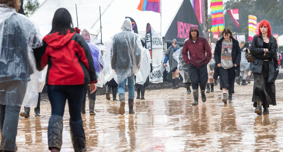 People in the rain and mud