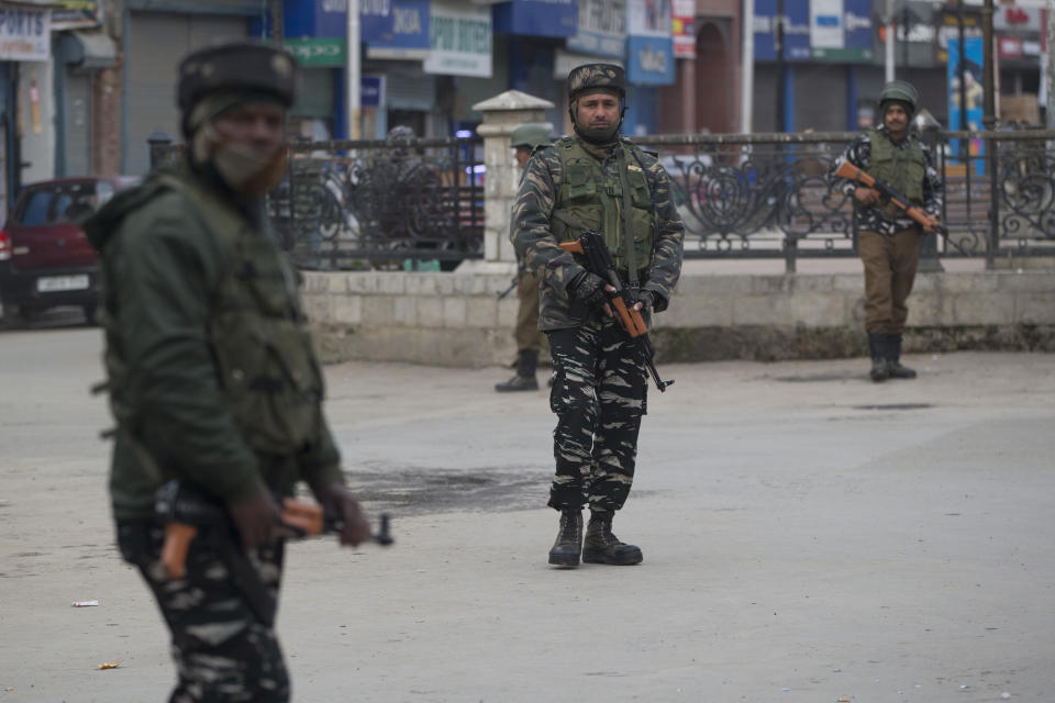 Indian paramilitary soldiers stand guard in a closed market in Srinagar, Indian controlled Kashmir, Saturday, Feb. 23, 2019. Police have arrested at least 200 activists seeking the end of Indian rule in disputed Kashmir, officials said Saturday, escalating fears among already wary residents that a sweeping crackdown could touch off renewed anti-India protests and clashes. (AP Photo/ Dar Yasin)