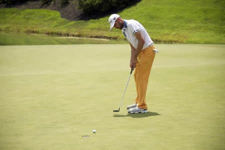 Troy Merritt sinks a putt on the 14th hole in the third round of the Quicken Loans National golf tournament at Robert Trent Jones Golf Club. Mandatory Credit: Rafael Suanes-USA TODAY Sports