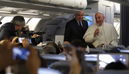 Pope Francis speaks with journalists during the flight from Rome to Colombo, Sri Lanka January 12, 2015. REUTERS/Stefano Rellandini