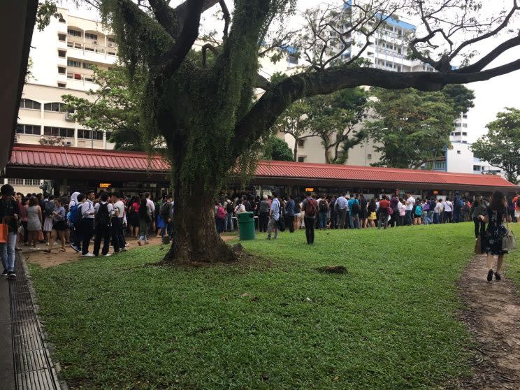 A bus stop outside the Eunos station was overcrowded with commuters after a train fault at Tanah Merah caused long travel delays along the East-West Line on 30 March 2017. (Photo: Nurul Azliah/Yahoo Singapore)