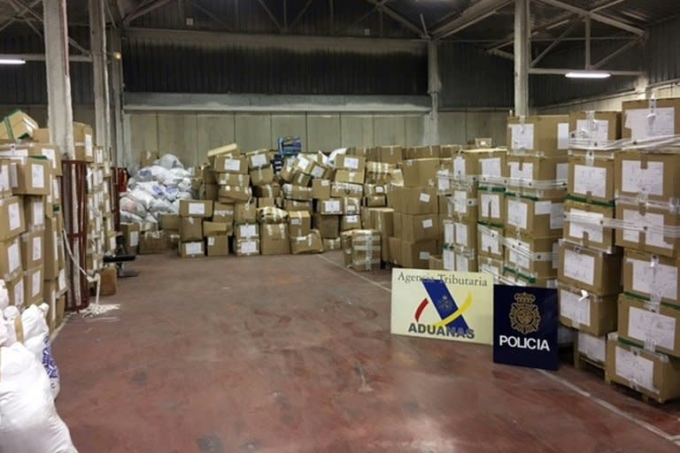 Boxes of counterfeit goods are piled up in a warehouse seized by police during the dismantling of a huge network selling counterfeit products in La Jonquera, a town on the border between France and Spain