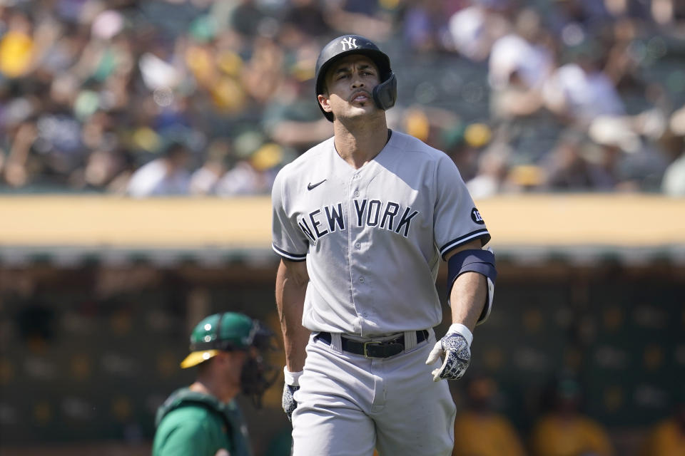 New York Yankees' Giancarlo Stanton walks to the dugout after striking out against the Oakland Athletics during the seventh inning of a baseball game in Oakland, Calif., Saturday, Aug. 28, 2021. (AP Photo/Jeff Chiu)
