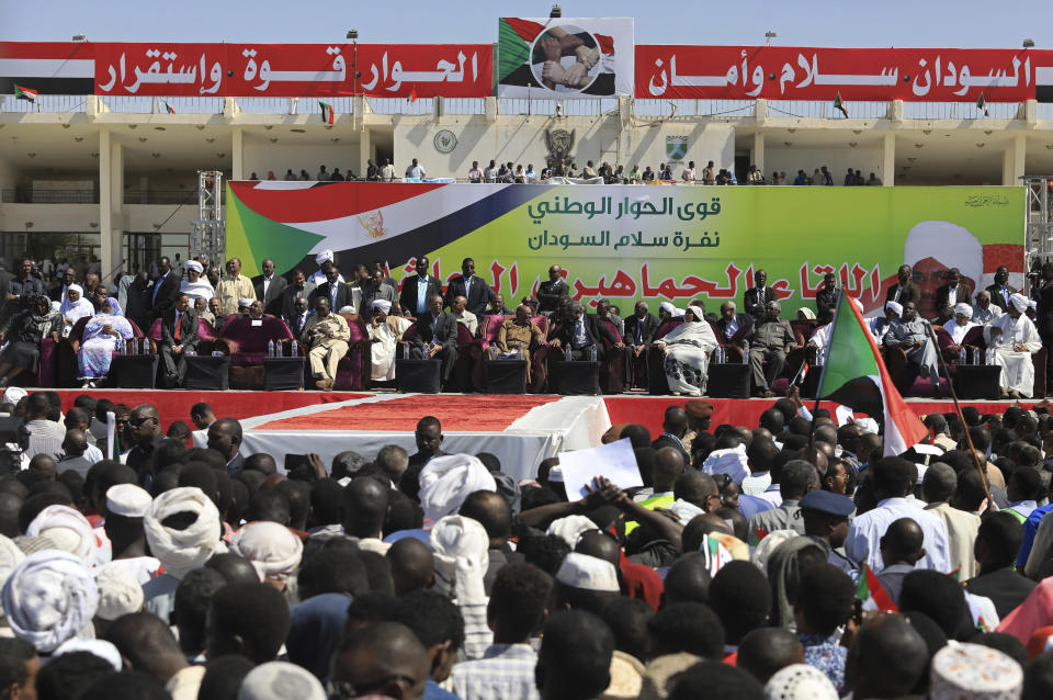 Sudan’s President Omar al-Bashir, center, and other dignitaries take the stage at a rally of supporters, in Khartoum, Sudan, Wednesday, Jan. 9, 2019. Al-Bashir told the gathering of several thousands of supporters in the capital that he is ready to step down only “through election.” The remarks come after three weeks of anti-government protests. (AP Photo/Mahmoud Hjaj)