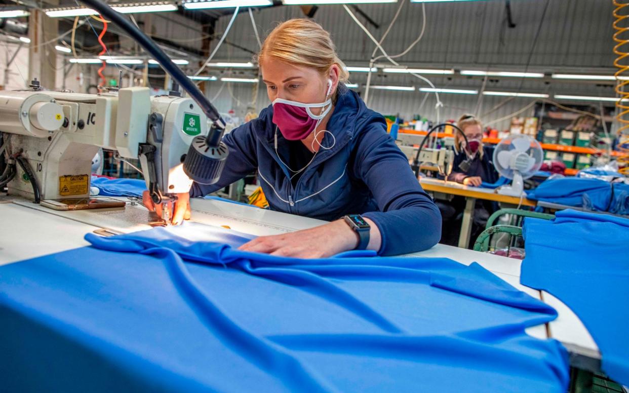 A woman makes PPE -  Paul Faith / AFP