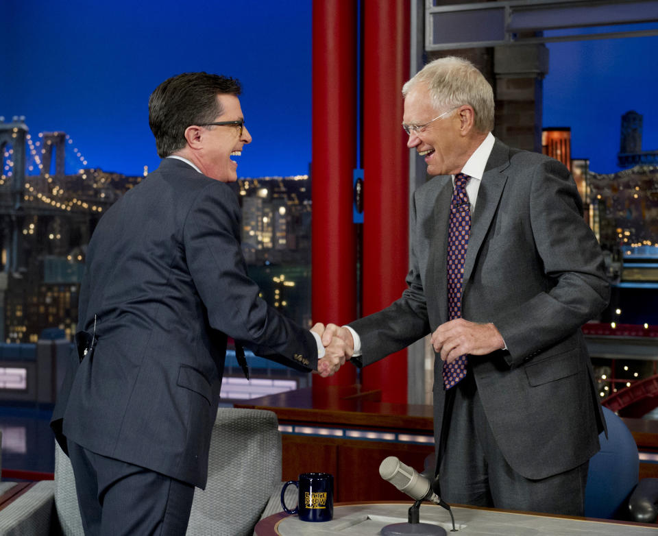 In this photo provided by CBS, Comedy Central’s Stephen Colbert, left, shakes hands with host David Letterman on the set of the “Late Show with David Letterman,” Tuesday, April 22, 2014, in New York. This was Colbert’s first visit to the show since CBS announced that he will succeed Letterman as host when he retires in 2015. (AP Photo/Jeffrey R. Staab) MANDATORY CREDIT, NO SALES, NO ARCHIVE, FOR NORTH AMERICAN USE ONLY