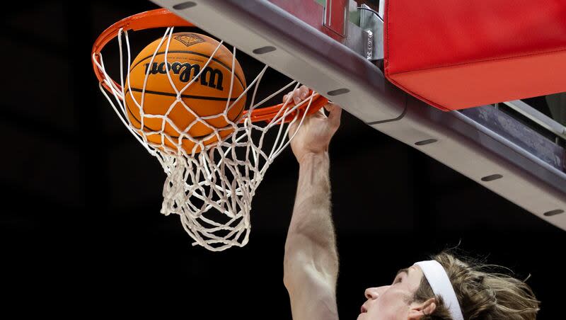 Utah Utes center Branden Carlson (35) dunks the ball during the second round of the National Invitation Tournament against the Iowa Hawkeyes at the Huntsman Center in Salt Lake City on Sunday, March 24, 2024.
