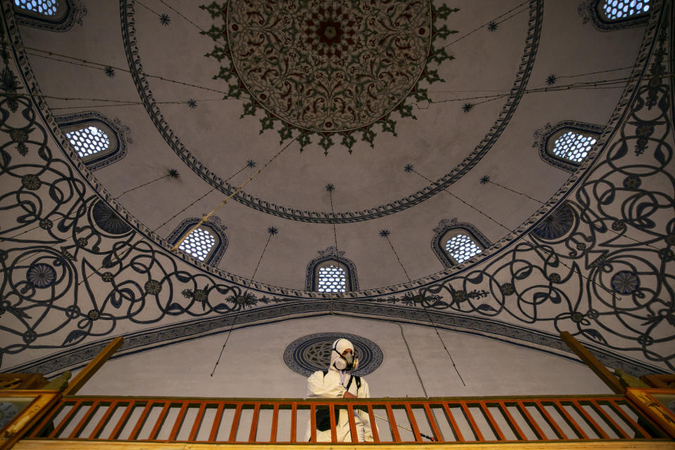 Disinfection team disinfect the premises of the grand mosque in capital Pristina, Kosovo on Thursday, May 28, 2020. Kosovo's mosques reopened on Thursday after more than two months of the virus lockdown. (AP Photo/Visar Kryeziu)