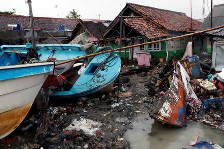 Vessels are washed up next to houses after a tsunami hit, in Anyer, Banten province, Indonesia December 25, 2018. REUTERS/Jorge Silva