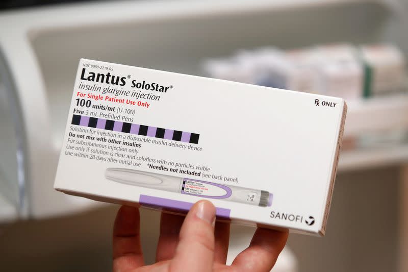 FILE PHOTO: A pharmacist holds a box of the drug Lantus SoloStar, made by Sanofi Pharmaceutical, at a pharmacy in Provo