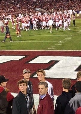 Kansas City Royals star Bobby Witt Jr. (back left) and Mississippi State third baseman Logan Kohler (back right) on the field for an Oklahoma football game.