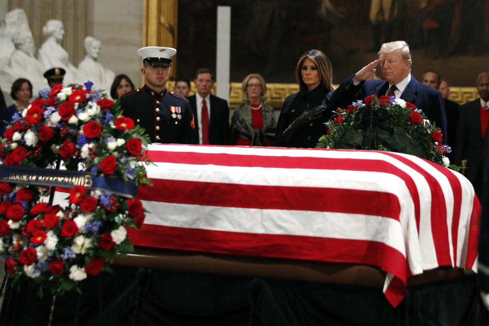 President Donald Trump and first lady Melania Trump pay their respects to former President George H.W. Bush, as he lies in state in the Rotunda of the U.S. Capitol, Monday, Dec. 3, 2018, in Washington. (AP Photo/Jacquelyn Martin)