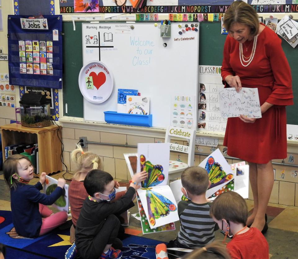 Ohio First Lady Fran DeWine with a card made for her by 10 students in Lisa Green's preschool class at the South Lawn Campus of Coshocton County Head Start. She read "The Very Hungry Caterpillar" to the kids and each received a copy of the book to take home.