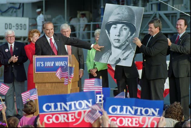 Dole points to a picture of himself as a 20-year-old Army private during a rally for himself and presidential running mate Jack Kemp in San Diego in 1996. (Photo: ASSOCIATED PRESS)