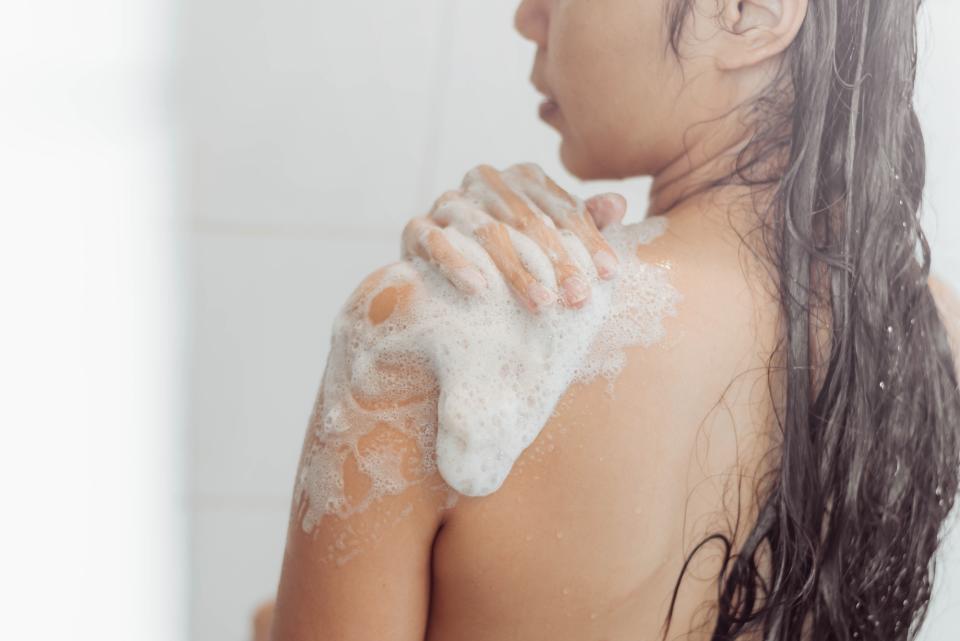 Woman-Washing-Body-In-Shower-Stock-Photo