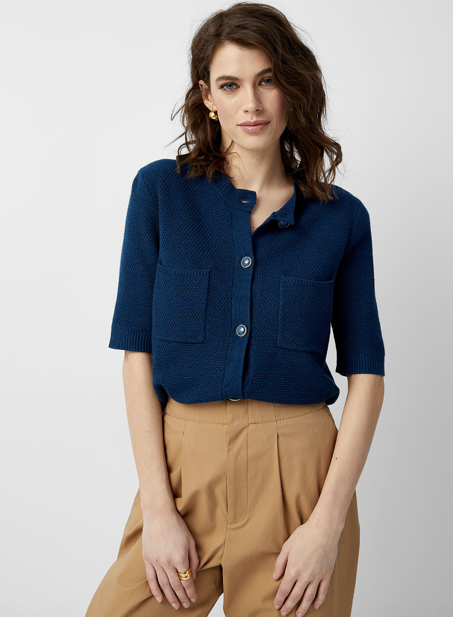 brunette model in beige pants and navy blue Jewel-Button Textured Cardigan (photo via Simons)