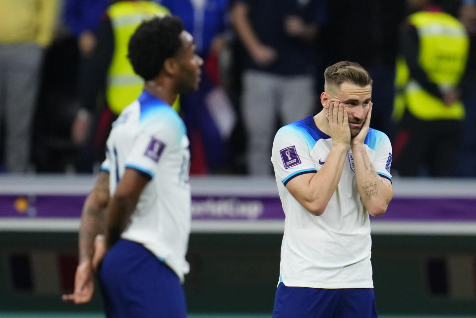 England's Luke Shaw, right, and Bukayo Saka react following the World Cup quarterfinal soccer match between England and France, at the Al Bayt Stadium in Al Khor, Qatar, Sunday, Dec. 11, 2022. (AP Photo/Natacha Pisarenko)