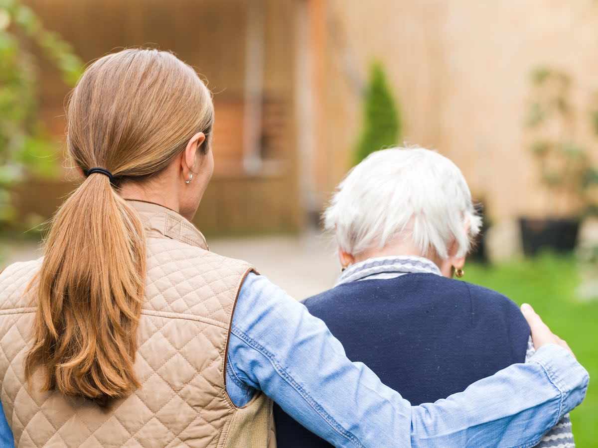 A carer looking after an older lady  (Getty/iStock)