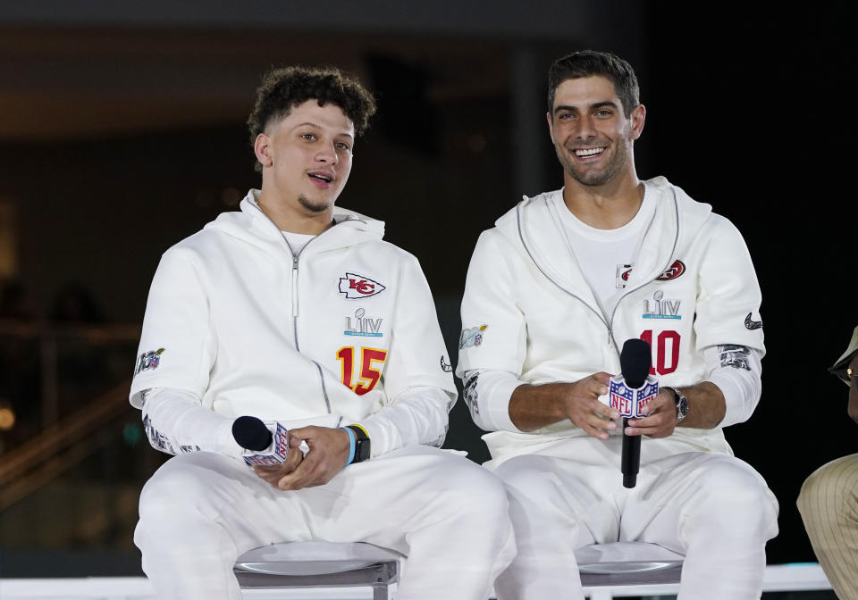 Kansas City Chiefs' Patrick Mahomes, right, chats with San Francisco 49ers' Jimmy Garoppolo during Opening Night for the NFL Super Bowl 54 football game Monday, Jan. 27, 2020, at Marlins Park in Miami. (AP Photo/David J. Phillip)