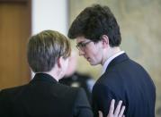 Owen Labrie speaks with his attorney Robin Melone during the first day of a hearing on whether he deserves a new trial, on Tuesday, Feb. 21, 2017 in Concord, N.H. Labrie claims his trial lawyers failed to challenge the felony charge. He was acquitted in 2015 of raping a 15-year-old classmate as part of a game of sexual conquest at St. Paul's School but was convicted of a felony computer charge requiring him to register as a sex offender. (Geoff Forester /The Concord Monitor via AP, Pool)