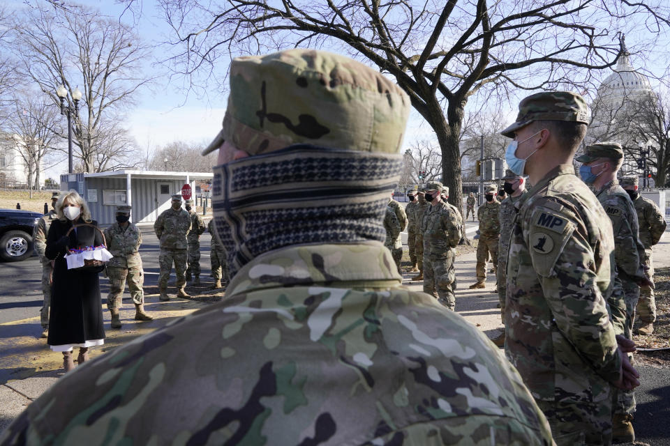 First lady Jill Biden surprises National Guard members outside the Capitol with chocolate chip cookies, Friday, Jan. 22, 2021, in Washington. (AP Photo/Jacquelyn Martin, Pool)