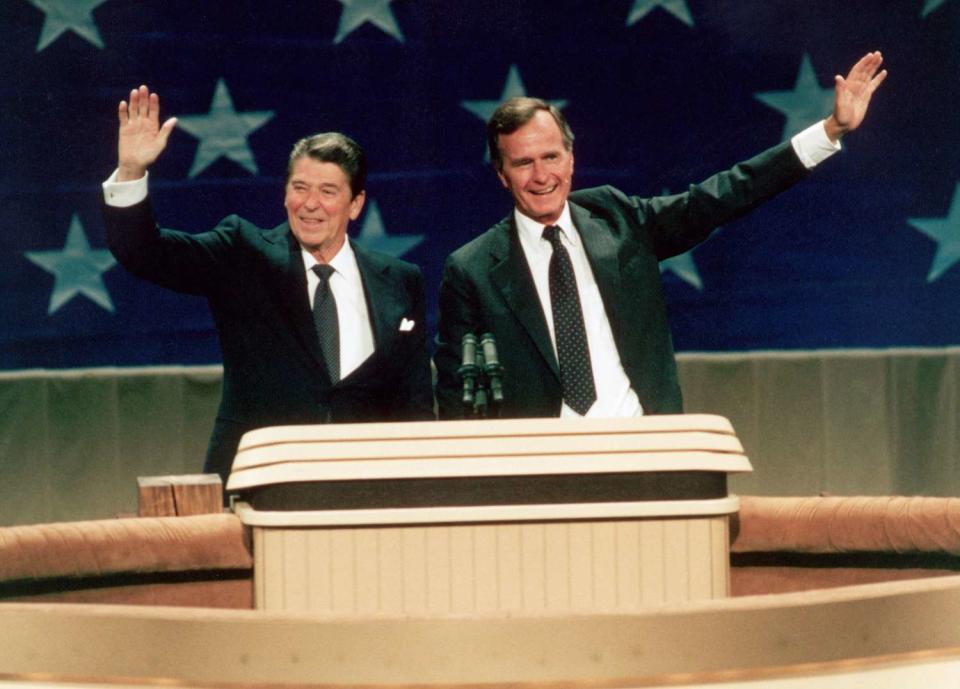 Ronald Reagan and George Bush, the Republican nominees for president and vice president, waving from the podium at the R