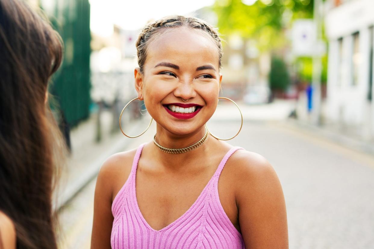 A woman wearing lipstick smiling