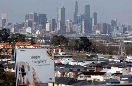 FILE PHOTO: An advertising sign for a new housing development area is seen with the Melbourne skyline in the distance