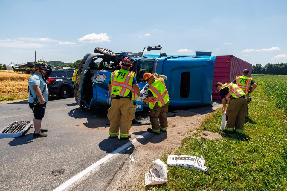 Emergency crews work at the scene where a tractor-trailer rolled over near the intersection of Karen Lane and Gitts Run Road, Friday, June 21, 2024, in Penn Township. The driver of the tractor-trailer was transported to the hospital.