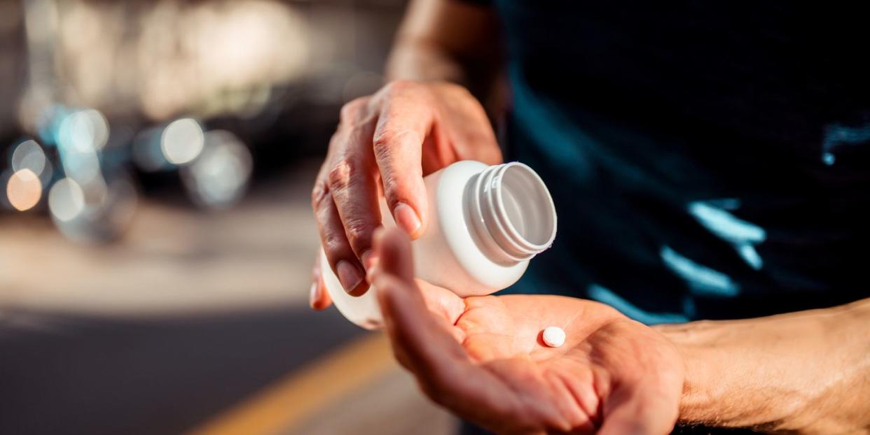 close up of human hands he is taking pill