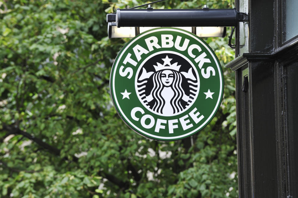 Edinburgh, Scotland - July 19, 2011:  A Starbucks Coffee sign outside a Starbucks Coffee outlet on Edinburgh's Royal Mile. Starbucks Corporation is an international coffee and coffeehouse chain based in Seattle, Washington.