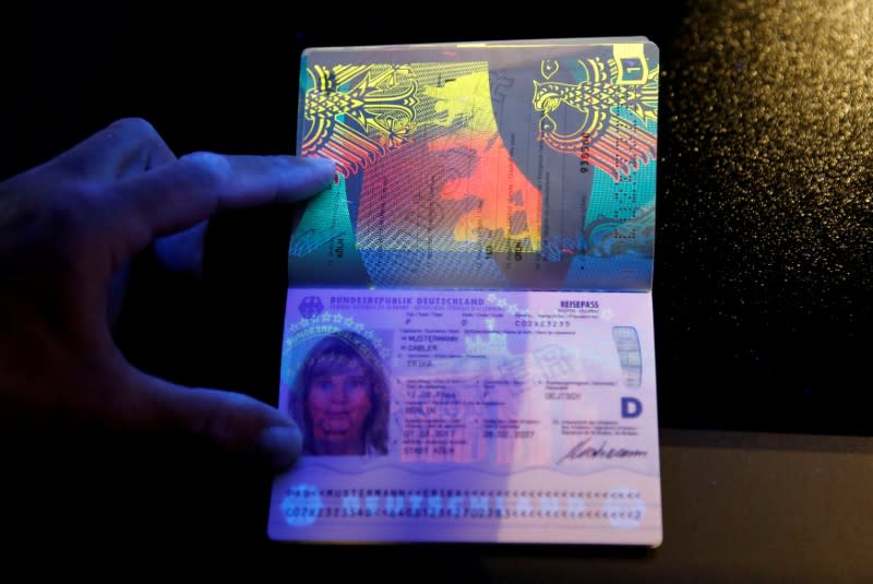 FILE PHOTO: A specimen of the new German electronic passport is pictured under an ultraviolet light during its presentation to the media in Berlin