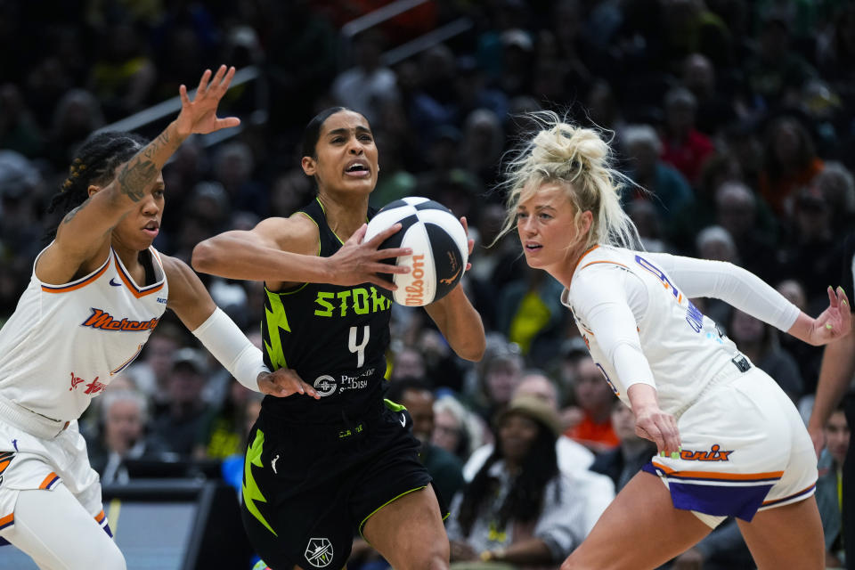 Seattle Storm guard Skylar Diggins-Smith (4) drives to the basket between Phoenix Mercury guard Sug Sutton, left, and guard Sophie Cunningham during the first half of a WNBA basketball game Tuesday, June 4, 2024, in Seattle. (AP Photo/Lindsey Wasson)