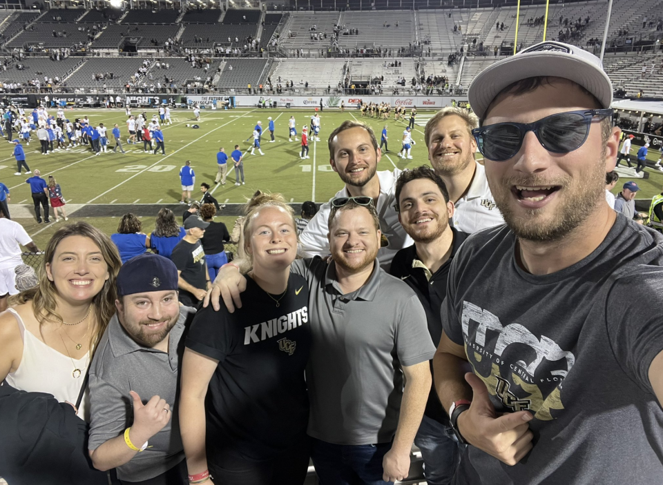 On the way to setting a record for the number of college football games attended in one season, Ben Chase (right) included a home game for the school where his love of college football began — UCF.