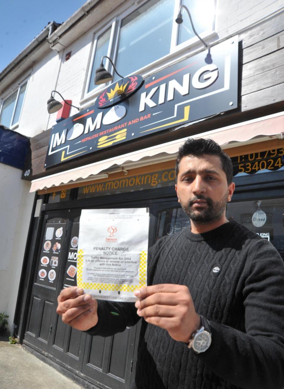 Swindon Advertiser: Momo King owner Sushil Paudel says the council needs to change after racking up parking fines for parking at the rear of his business