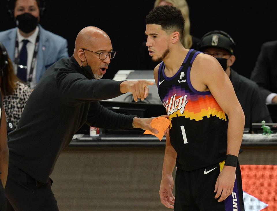 Phoenix Suns head coach Monty Williams speaks with guard Devin Booker during the first half in Game 2 of the NBA Finals vs. the Milwaukee Bucks at Phoenix Suns Arena, July 8, 2021.