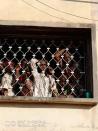 People look out from a window before being freed by police from an Islamic rehabilitation centre in Ibadan