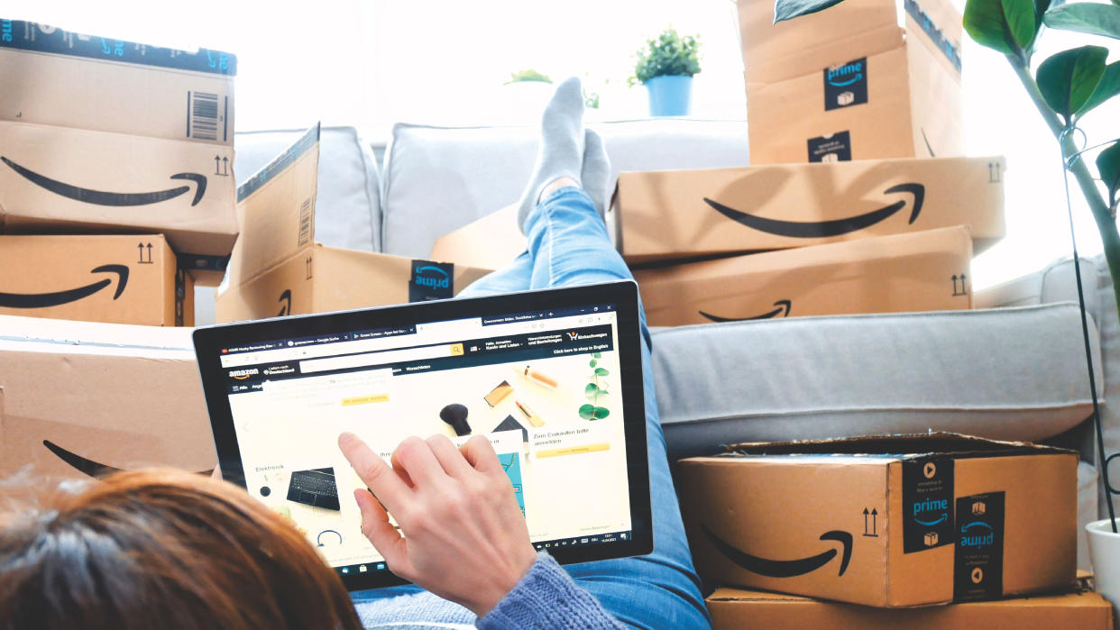  Stack of Amazon Prime packages. woman shopping online at Amazon Prime Day. 