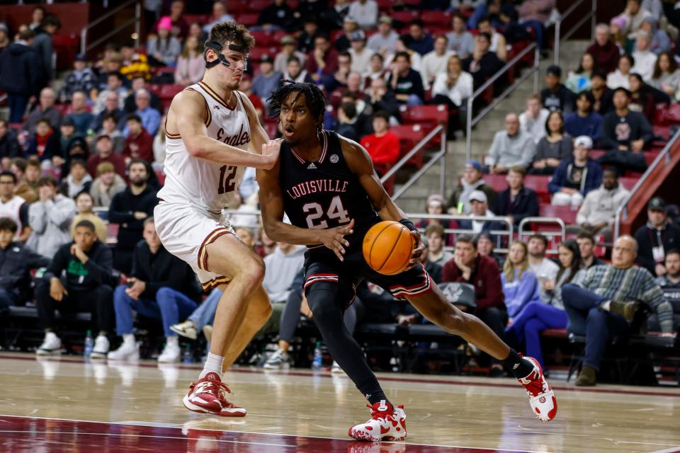 Louisville forward Jae'Lyn Withers (24) drives against Boston College forward Quinten Post (12) during the second half of an NCAA college basketball game Wednesday, Jan. 25, 2023, in Boston. (AP Photo/Greg M. Cooper)