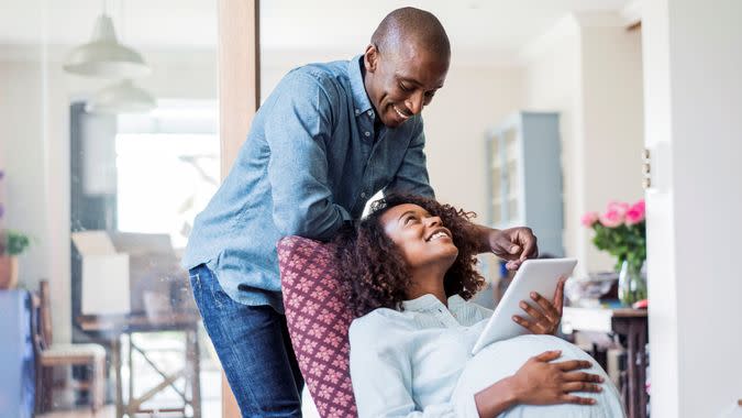 A photo of pregnant woman looking at man.