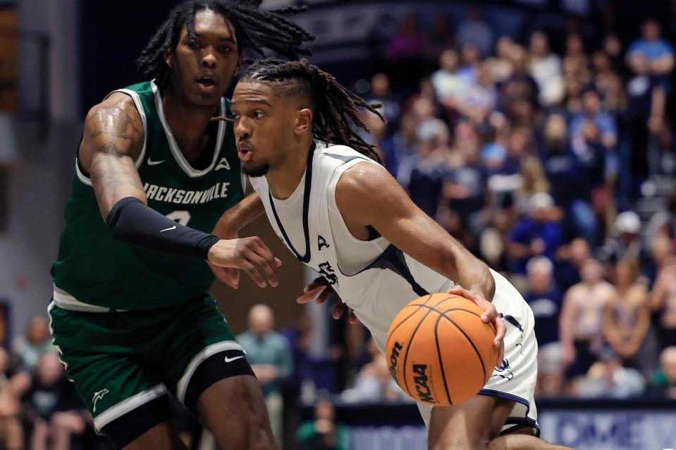 North Florida Ospreys guard Chaz Lanier (2) dribbles against Jacksonville Dolphins forward Stephon Payne III (0) during the second half of an NCAA men’s basketball game Friday, Jan. 12, 2024 at the University of North Florida’s UNF Arena in Jacksonville, Fla. UNF defeated JU 82-74. [Corey Perrine/Florida Times-Union]