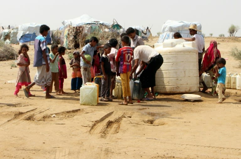 Displaced Yemenis from Hodeida fill their water containers at a make-shift camp in Hajjah province, on September 16, 2018