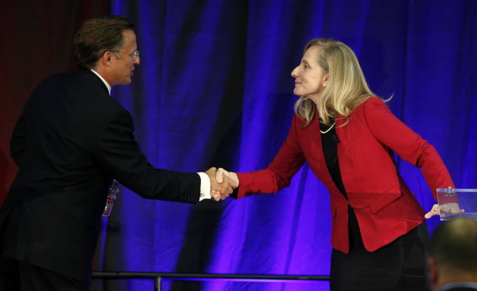 In this Oct. 15, 2018 photo, Virginia Congressman Dave Brat, R-Va., left, shakes hands with Democratic challenger Abigail Spanberger, right, after a debate at Germanna Community College in Culpeper, Va. The path to power in the House runs through a few dozen districts in Tuesday’s election, with Republicans defending their majority and Democrats looking to gain 23 seats they would need to win control. (AP Photo/Steve Helber)