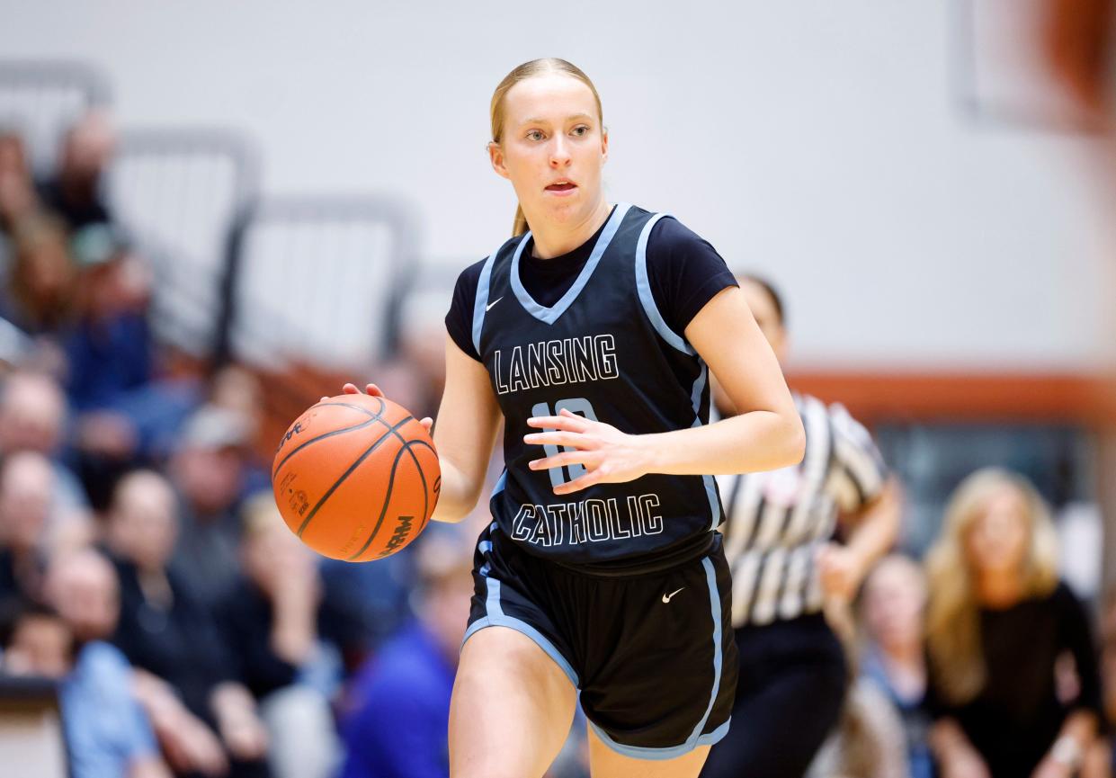 Lansing Catholic's Anna Richards moves the ball up court against Tecumseh, Wednesday, March 13, 2024, at Charlotte High School.
