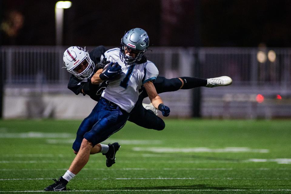 John Jay's Evan Rossi runs up field as a Scarsdale defender attempts the tackle during gets a Section 1 quarterfinal football game on Oct. 27, 2023.